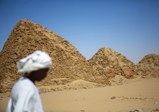 Sudan, Nubia, Nuri, Sudanese man in front of the royal pyramids of napata