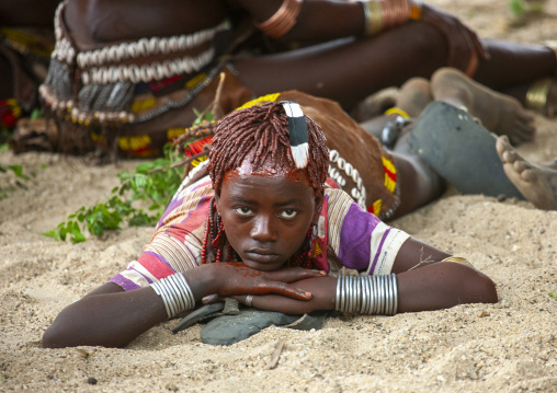 Young Hamer woman resting during bull leaping ceremony, Omo valley, Turmi, Ethiopia