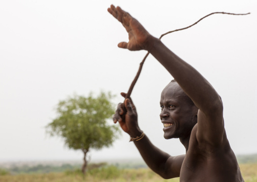 Karo tribe man using a whip, Omo valley, Korcho, Ethiopia