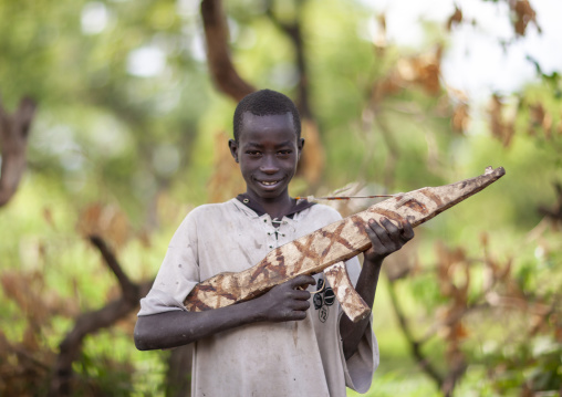 Surma tribe boy with a fake wooden kalashnikov, Omo valley, Kibish, Ethiopia