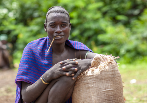 Menit tribe man with a traditional toothbrush, Omo valley, Tum, Ethiopia