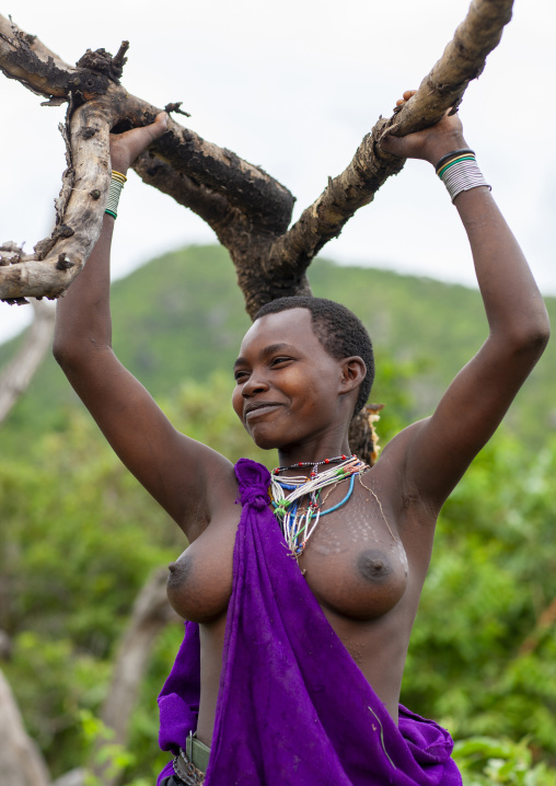Surma woman carrying tree branches, Omo valley, Ethiopia