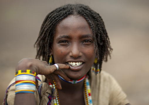 Portrait of a smiling Karrayyu young woman, Oromia, Metahara, Ethiopia