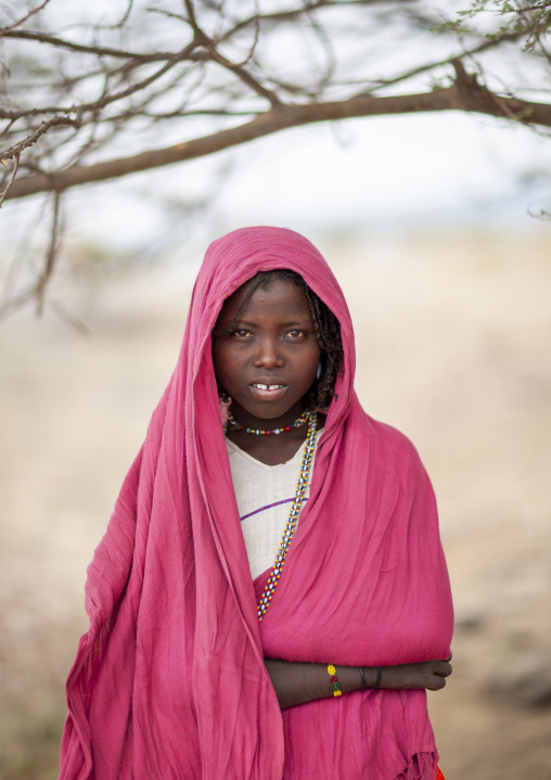 Portrait of a Karrayyu teenage girl with pink shawl, Oromia, Metahara, Ethiopia