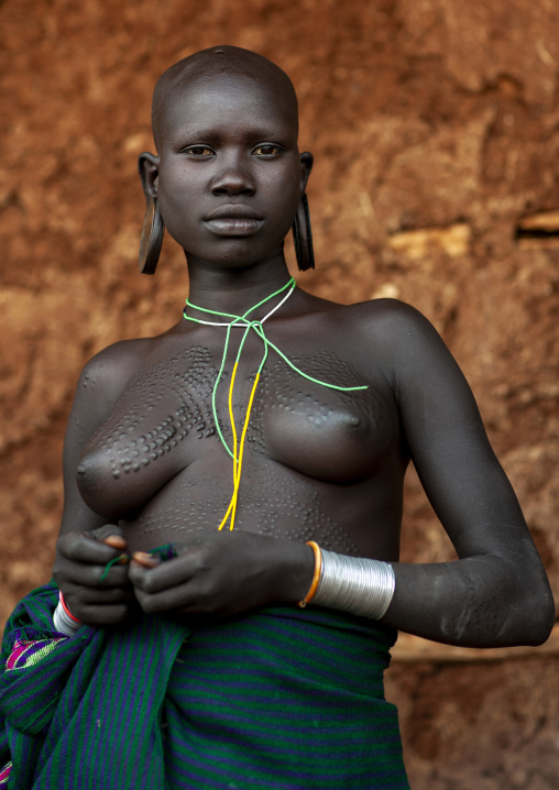 Suri tribe woman with traditional scarifications, Kibish, Omo valley, Ethiopia