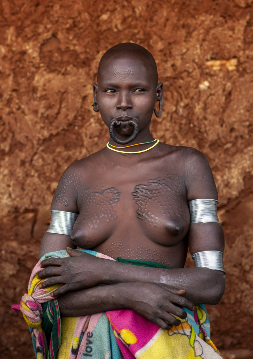 Suri tribe woman with traditional scarifications, Kibish, Omo valley, Ethiopia