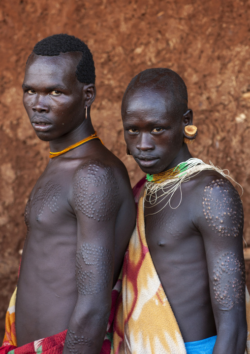 Suri tribe men with scarifications, Kibish, Omo valley, Ethiopia