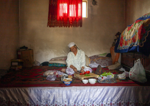 Woman preparing food in her home, Keriya,Xinjiang uyghur autonomous region, China