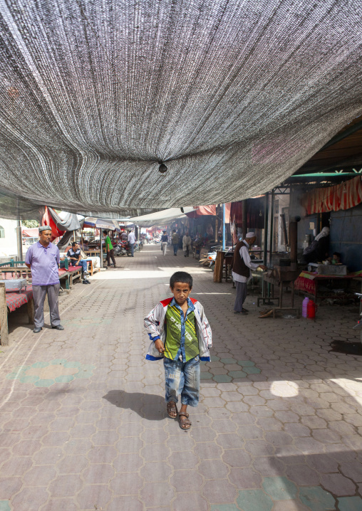 Young boy walking hin the market, Keriya, Xinjiang uyghur autonomous region, China