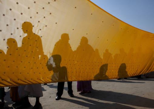 Women drying saris during maha kumbh mela, Uttar Pradesh, Allahabad, India