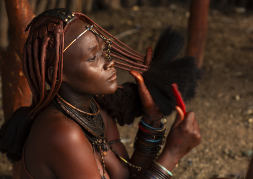 Himba woman taking care of her hair, Kunene region, Epupa, Namibia