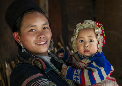 Black Hmong mother and baby in traditional clothes, Lao Cai province, Sapa, Vietnam