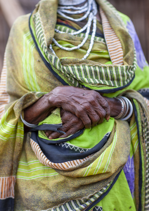 Joined hands on the belly of senior borana tribe woman, Oromia, Soda, Ethiopia