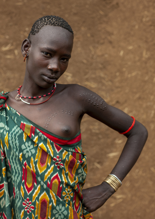 Bodi tribe woman with traditional hairstyle and scarifications, Hana Mursi, Omo valley, Ethiopia