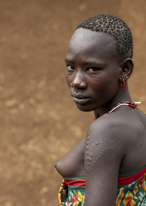Bodi tribe woman with traditional hairstyle and scarifications, Hana Mursi, Omo valley, Ethiopia