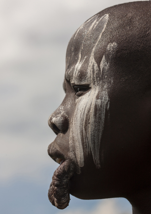Mursi tribe woman with enlarged lip and ears , Mago national park, Omo valley, Ethiopia