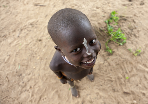 Over view portrait of Karo kid with clay on his nose, Korcho, Omo valley, Ethiopia