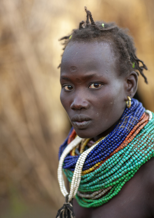Nyangatom senior tribe woman with necklaces, Omo valley, Murile, Ethiopia