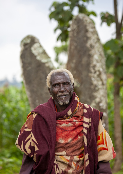 Old man in front of phallic shaped steles, South Ethiopia Regional State, Gedeo, Ethiopia