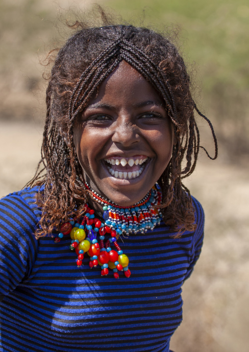Afar tribe girl with sharpened teeth laughing, Assaita, Afar regional state, Ethiopia