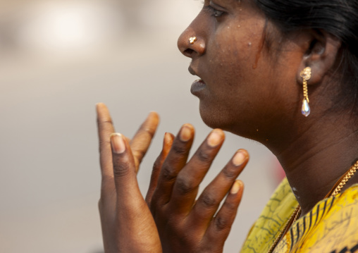 Woman praying during the masi magam festival, Puducherry district, Pondicherry, India