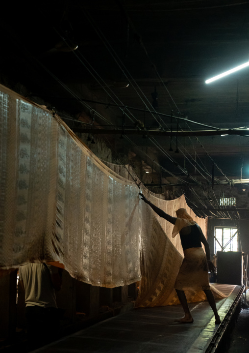 Indian worker drying textiles after manual Screen Printing, Rajasthan, Jaipur, India