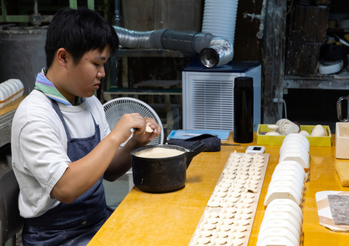 Artisan working in Genemongama porcelain atelier, Kyushu region, Arita, Japan