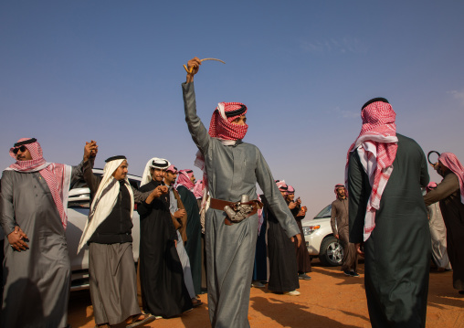 Saudi men dancing during King Abdul Aziz Camel Festival, Riyadh Province, Rimah, Saudi Arabia