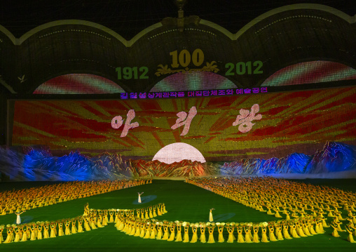 Dancers in front of rising sun over mount Paektu boards during Arirang, DGC, Pyongyang, North Korea