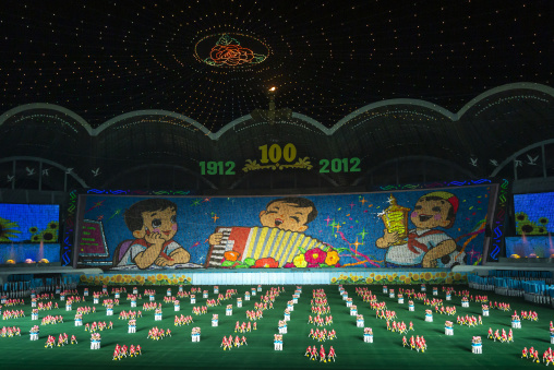 Children holding up boards during Arirang to create a boy playing accordion, DGC, Pyongyang, North Korea