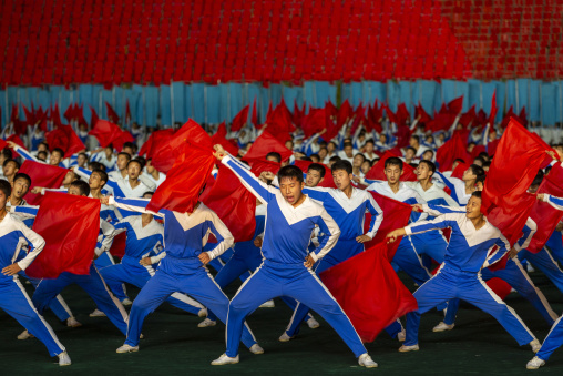 North Korean gymnasts with red flags during the Arirang mass games, DGC, Pyongyang, North Korea
