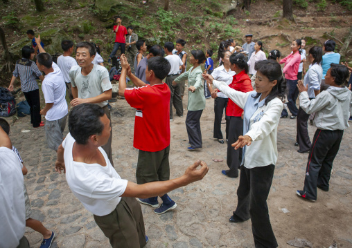 North Korean electricity company workers dancing in a park, North Hwanghae, Kaesong, North Korea