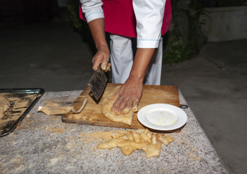 North Korean cook preparing tteok in a restaurant, North Hwanghae, Kaesong, North Korea