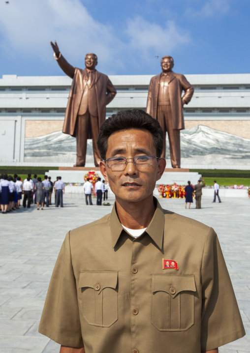 Man in front of the statues of the Leaders in Mansudae Grand monument, DGC, Pyongyang, North Korea