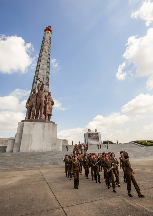 North Korean female soldiers posing in front of the Juche tower, DGC, Pyongyang, North Korea