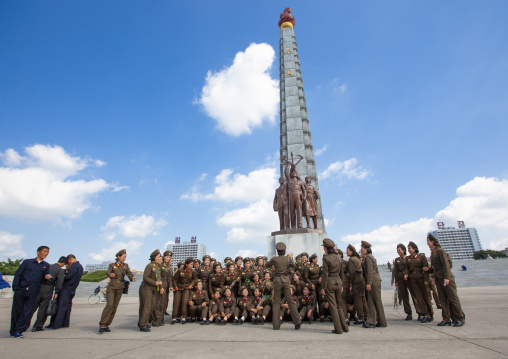 North Korean female soldiers posing in front of the Juche tower, DGC, Pyongyang, North Korea