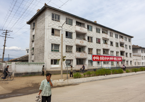 North Korean people in front of propaganda billboards, South Hamgyong, Hamhung, North Korea