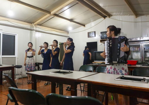 North Korean waitresses singing karaoke in a restautant, DGC, Pyongyang, North Korea