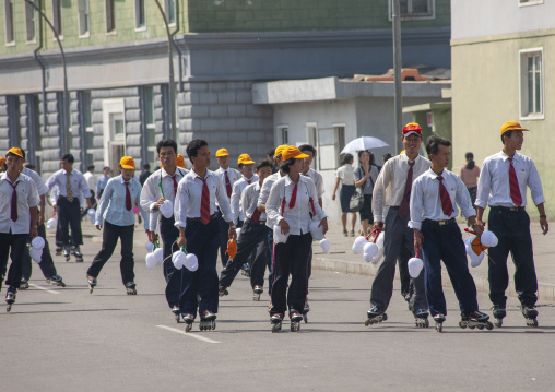 North Korean men with rollers in the street, DGC, Pyongyang, North Korea