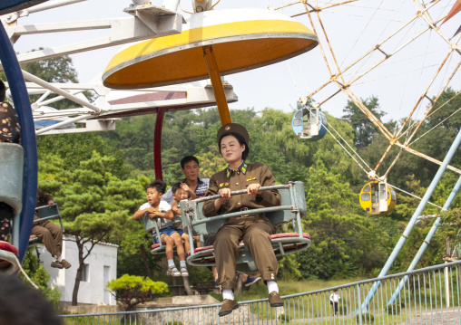North Korean female soldier on an attraction in Taesongsan funfair, DGC, Pyongyang, North Korea