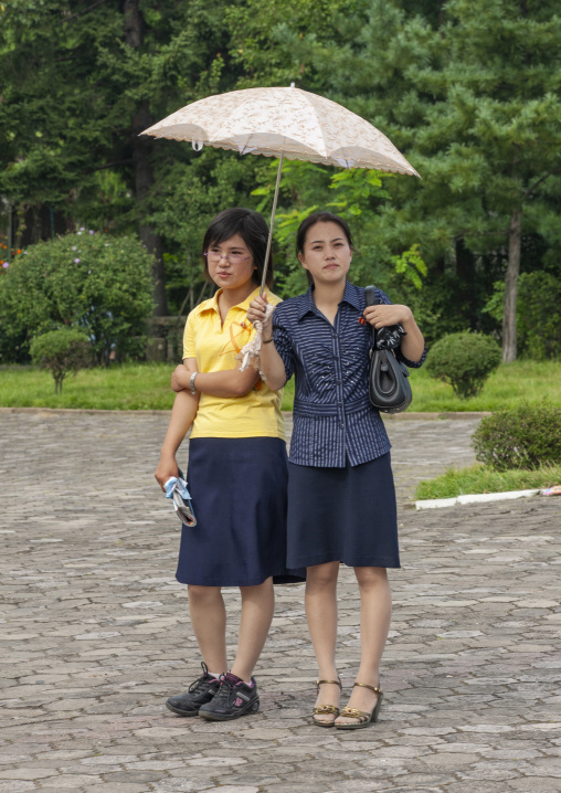 North Korean women with a umbrella in the street, DGC, Pyongyang, North Korea