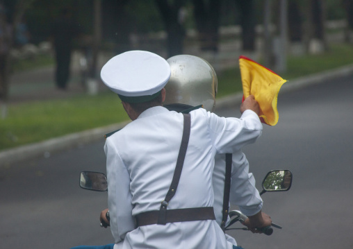 North Korean male traffic security officers on a motorbike, South DGC, Nampo, North Korea