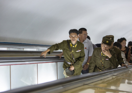 North Korean soldiers using escalator leading to the subway station, DGC, Pyongyang, North Korea