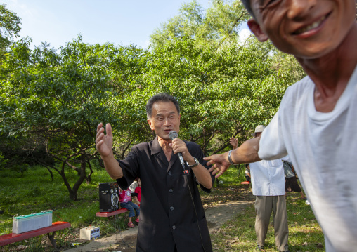 North Korean men singing in a park on national day, DGC, Pyongyang, North Korea
