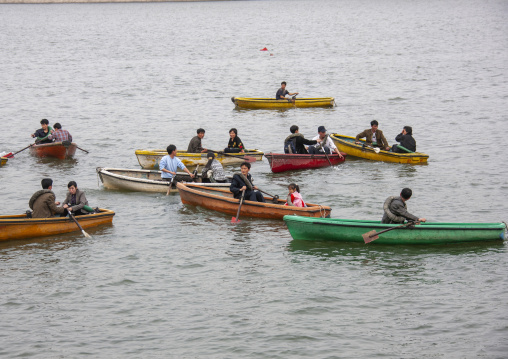 North Korean people in rowing boats on Taedong river, DGC, Pyongyang, North Korea