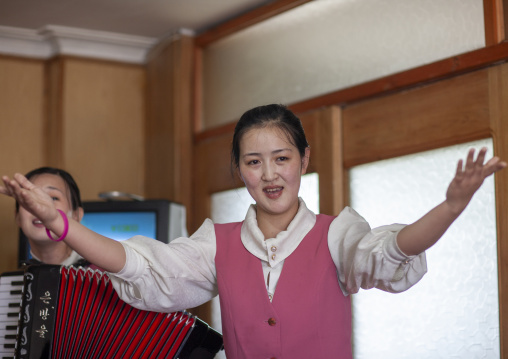 North Korean waitress singing in a restaurant, DGC, Pyongyang, North Korea