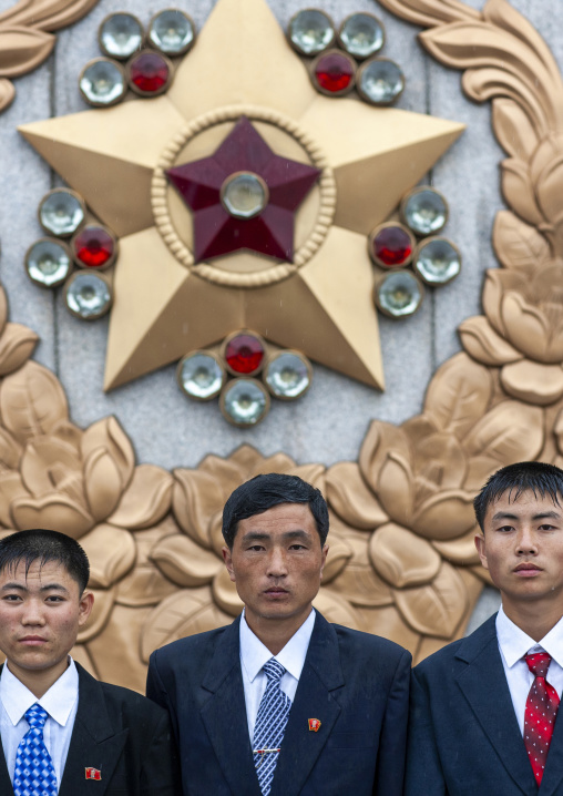 North Korean men under the rain in Kumsusan memorial palace, DGC, Pyongyang, North Korea