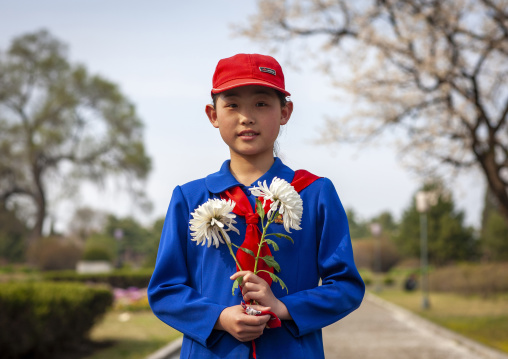 Young North Korean pioneer girl with flowers, DGC, Pyongyang, North Korea