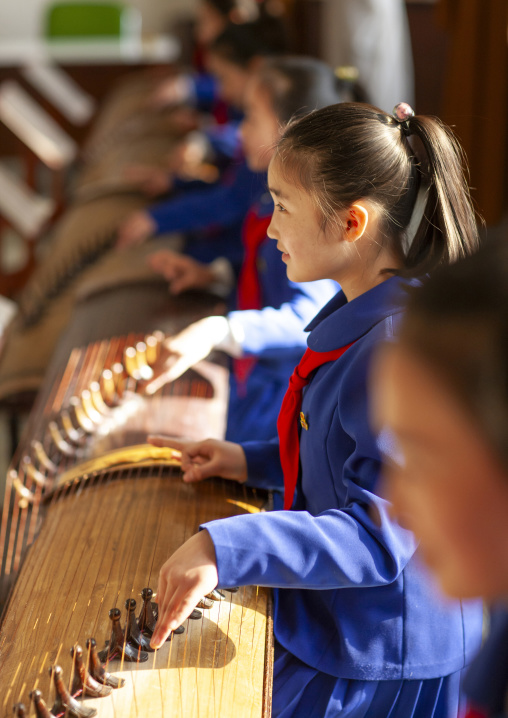 North Korean girls playing kayagum in Mangyongdae schoolchildren's palace, DGC, Pyongyang, North Korea