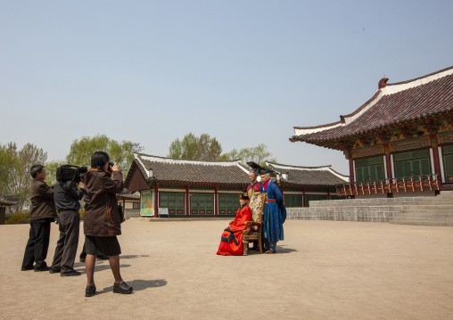 Tourists wearing traditional korean clothes in Chollima movie studio, DGC, Pyongyang, North Korea